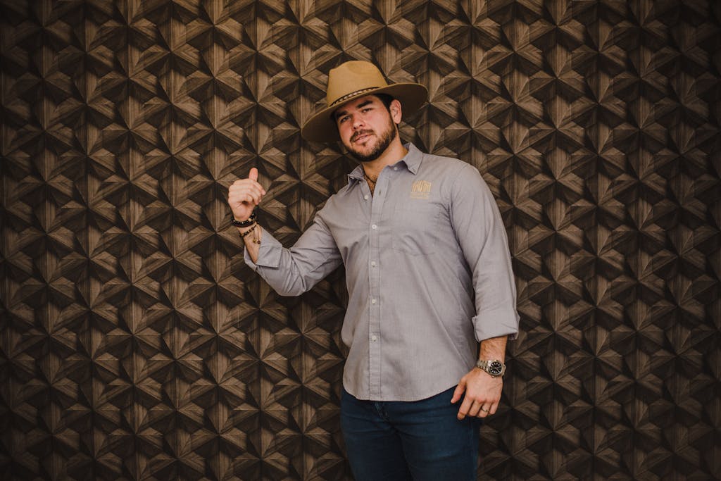 Portrait of Smiling Man in Hat Making Hand Gesture